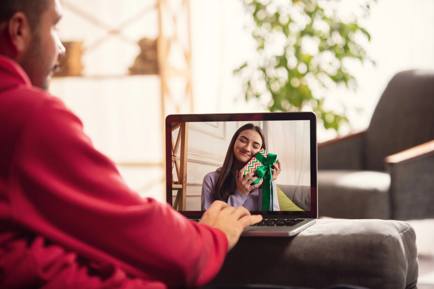 Two people talking over a laptop video call